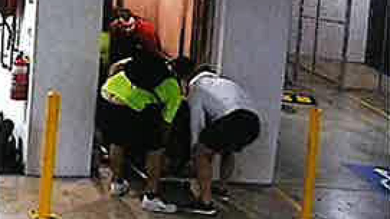 The accused carrying the cabinet