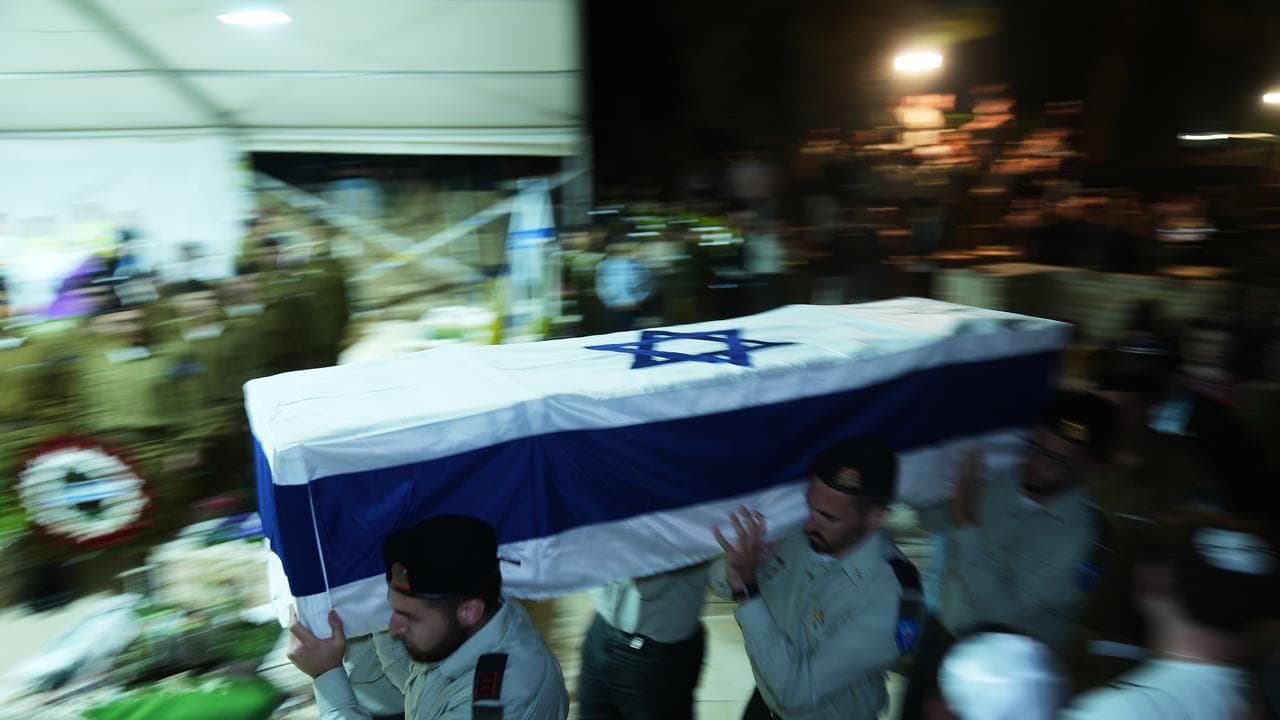 Israeli soldiers carry the coffin of slain hostage Daniel Peretz