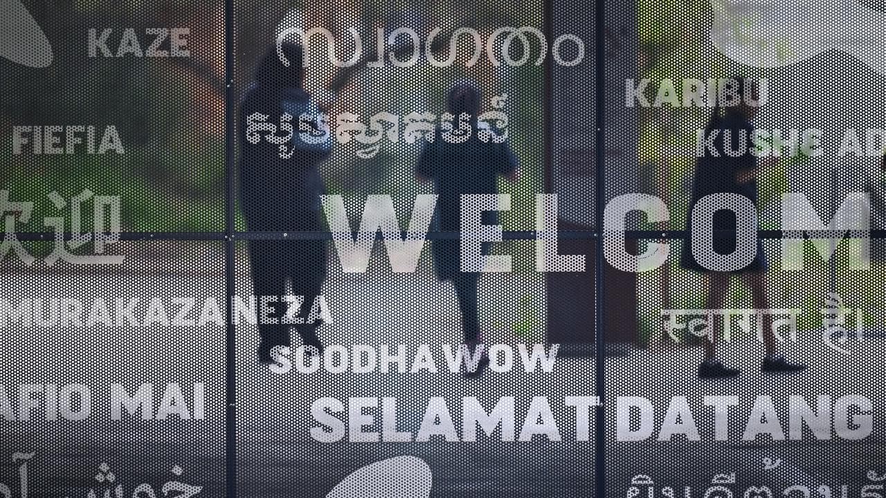 School students behind screen showing various languages (file)