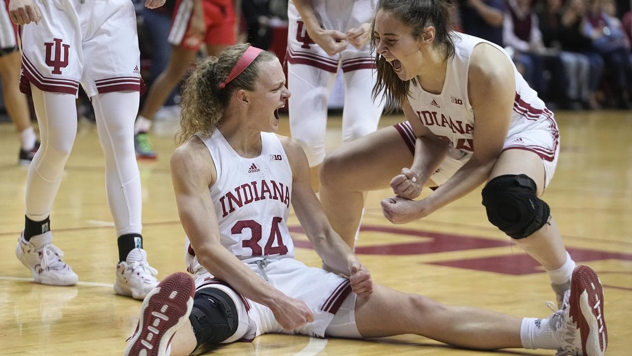 Grace Berger (34) and current Geelong player Mackenzie Holmes.