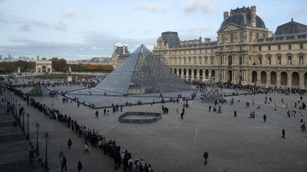 People queue outside the Louvre museum