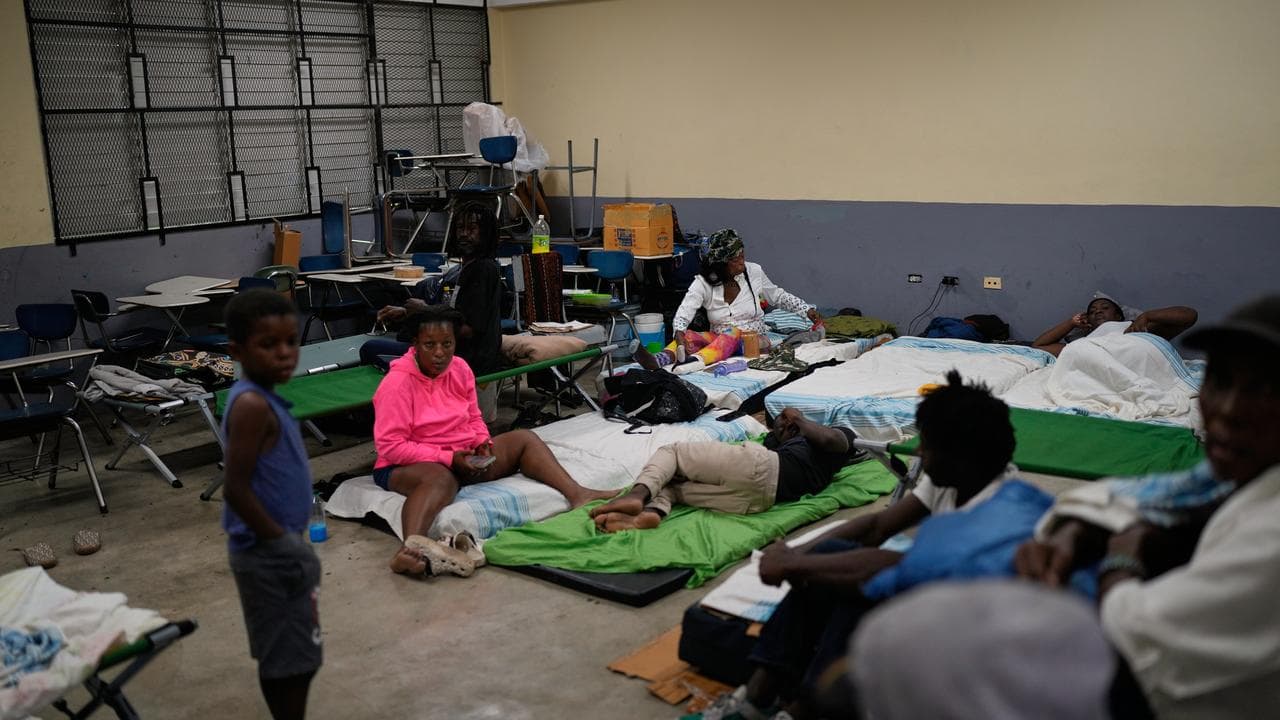 People take shelter in a school in Jamaica before Hurricane Melissa