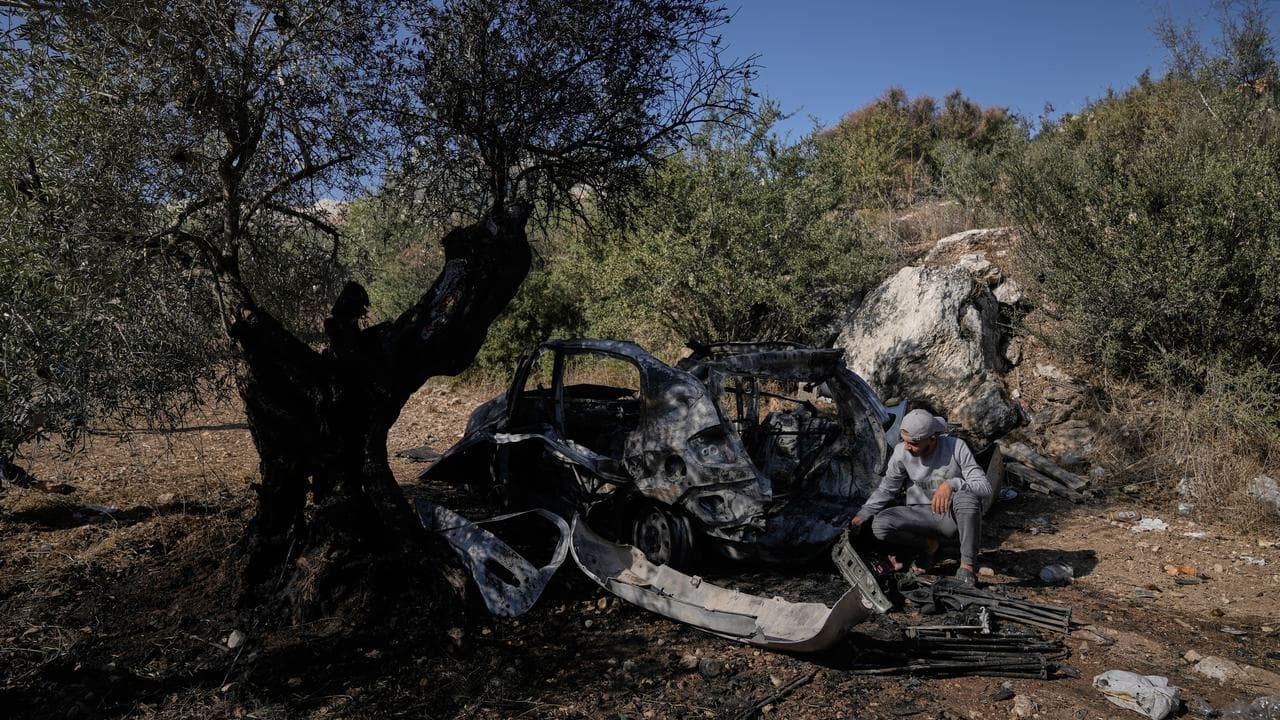 People inspect where Israeli police killed three militants near Jenin