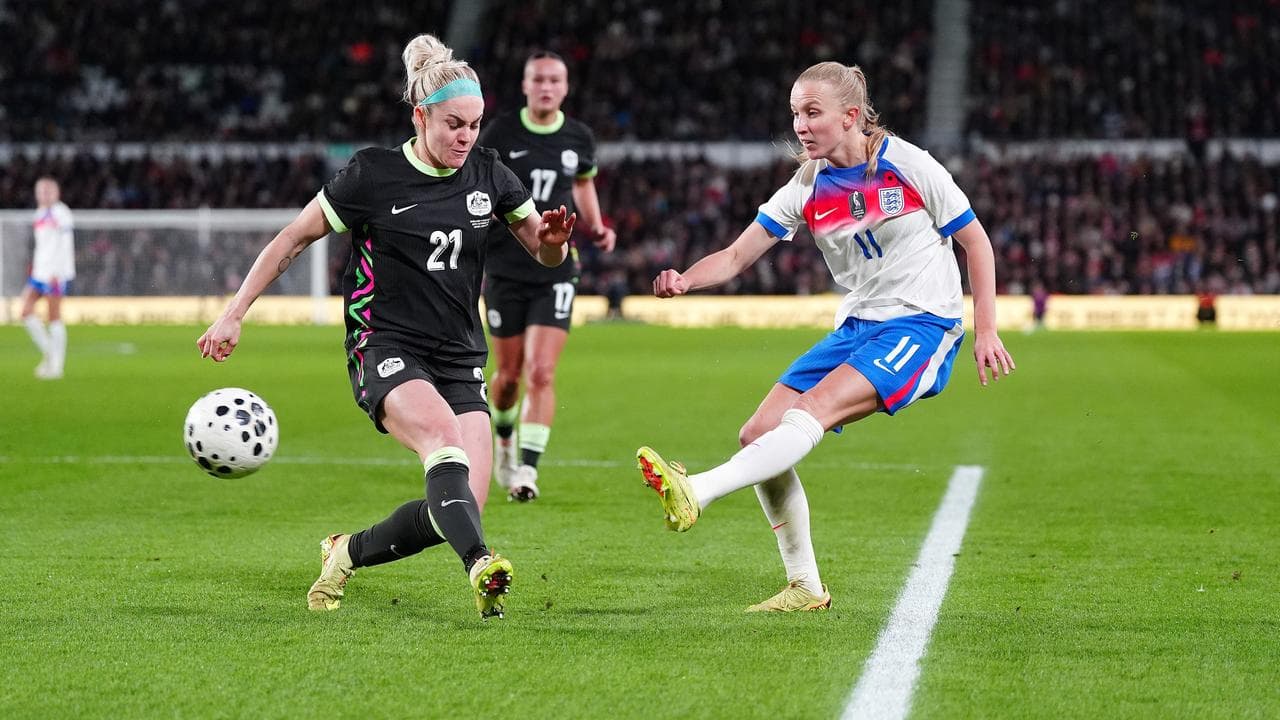 Ellie Carpenter puts pressure on England's Aggie Beever-Jones.