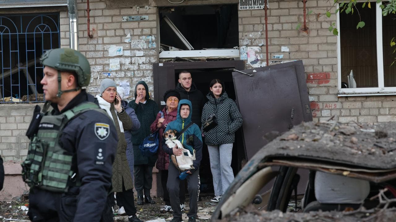Residents after a Russian missile hit their hostel in Zaporizhzhia