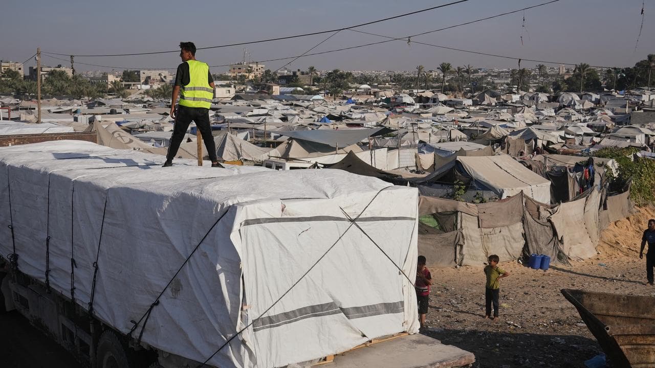 rucks carrying aid drive through Khan Younis, southern Gaza Strip