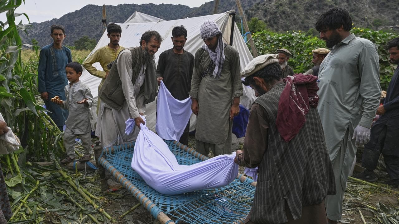 Body of a girl is carried after a powerful earthquake in Afghanistan