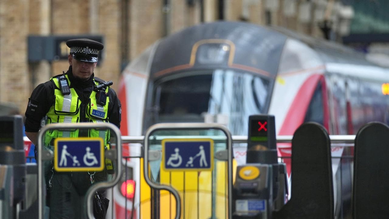 A police officer patrols King's Cross train station