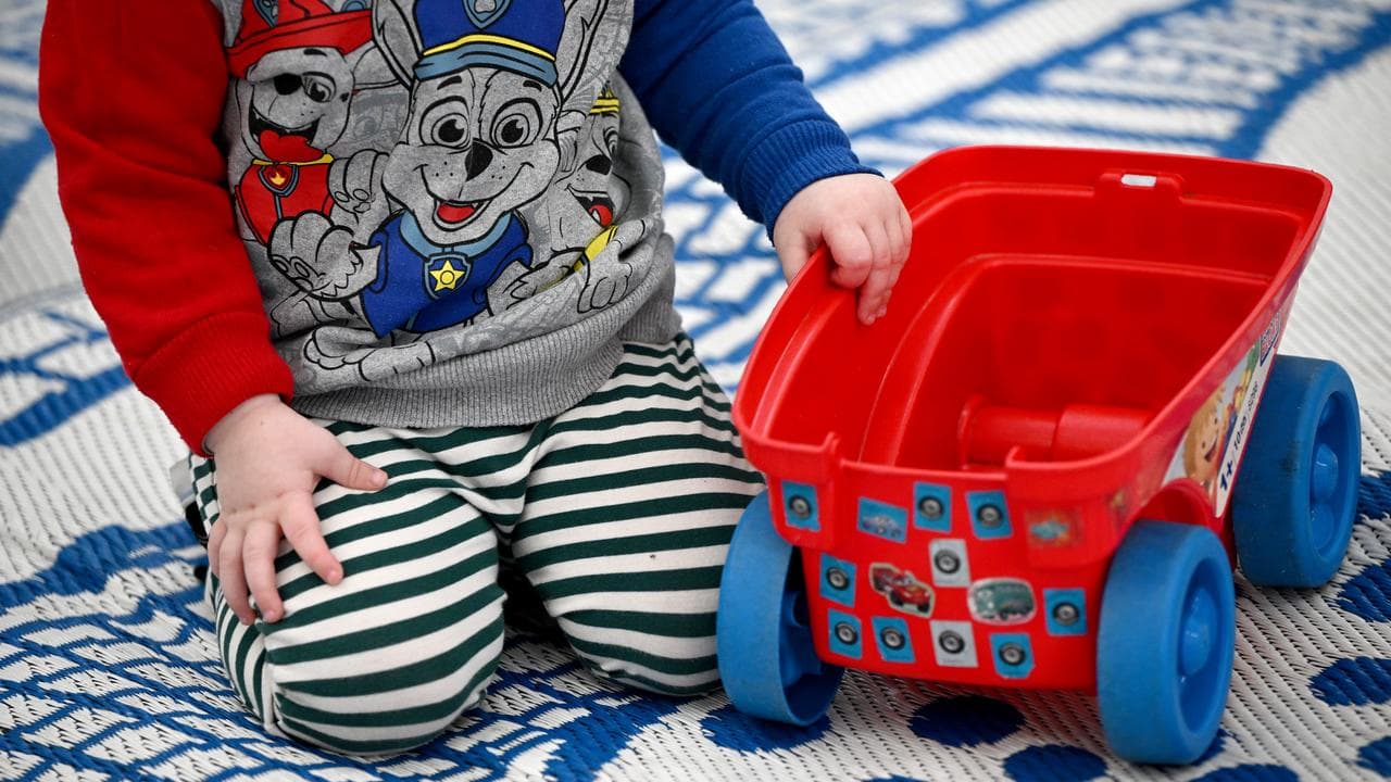 Young children play with toys