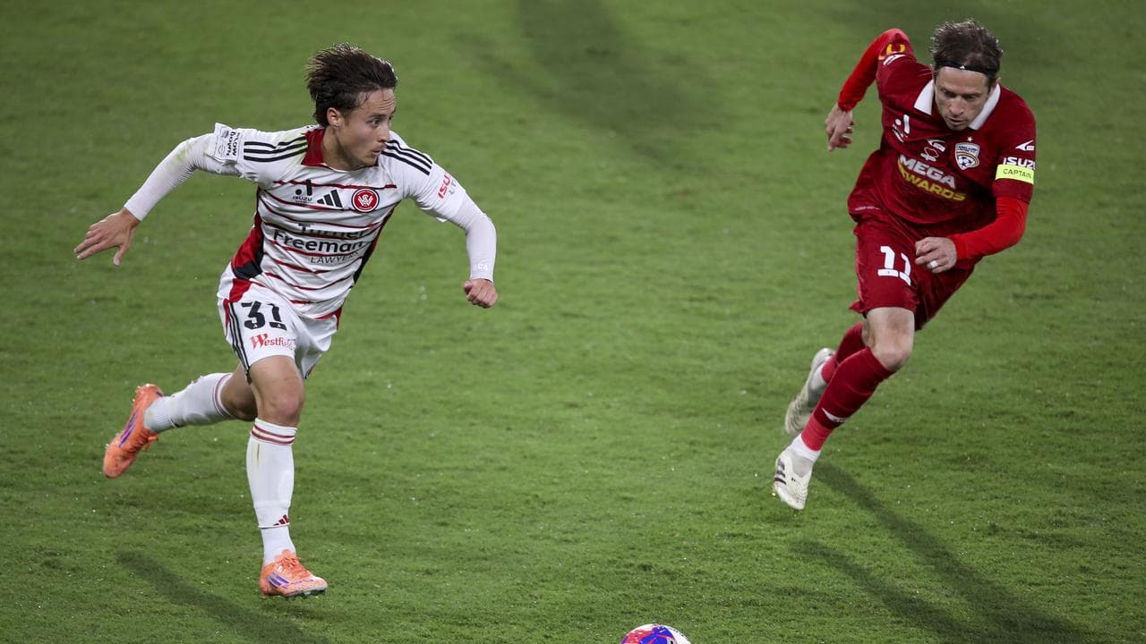 Aidan Simmons looks to pass while under pressure from  Craig Goodwin.