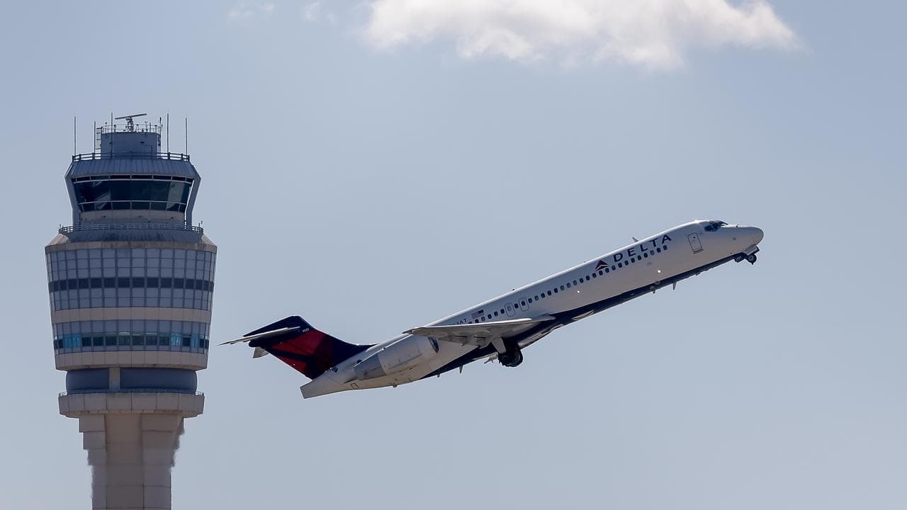 Atlanta air control tower and a Delta plane