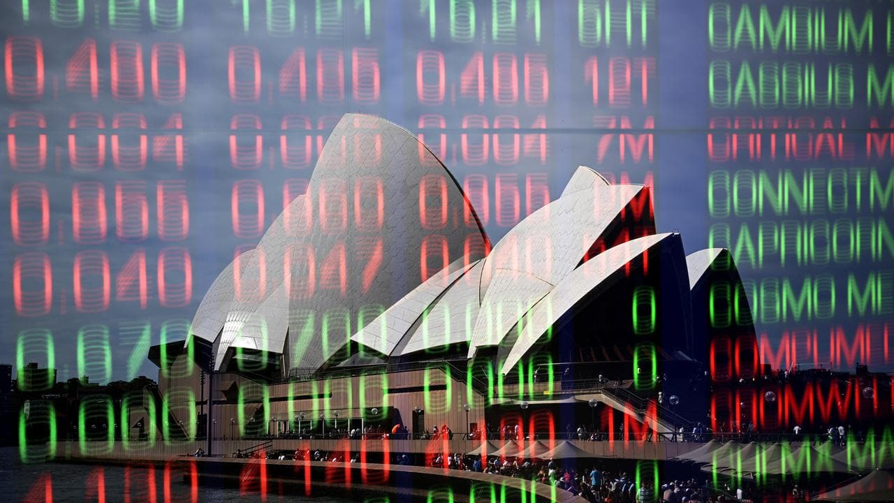A photo of the Sydney Opera House and stock indicator boards.