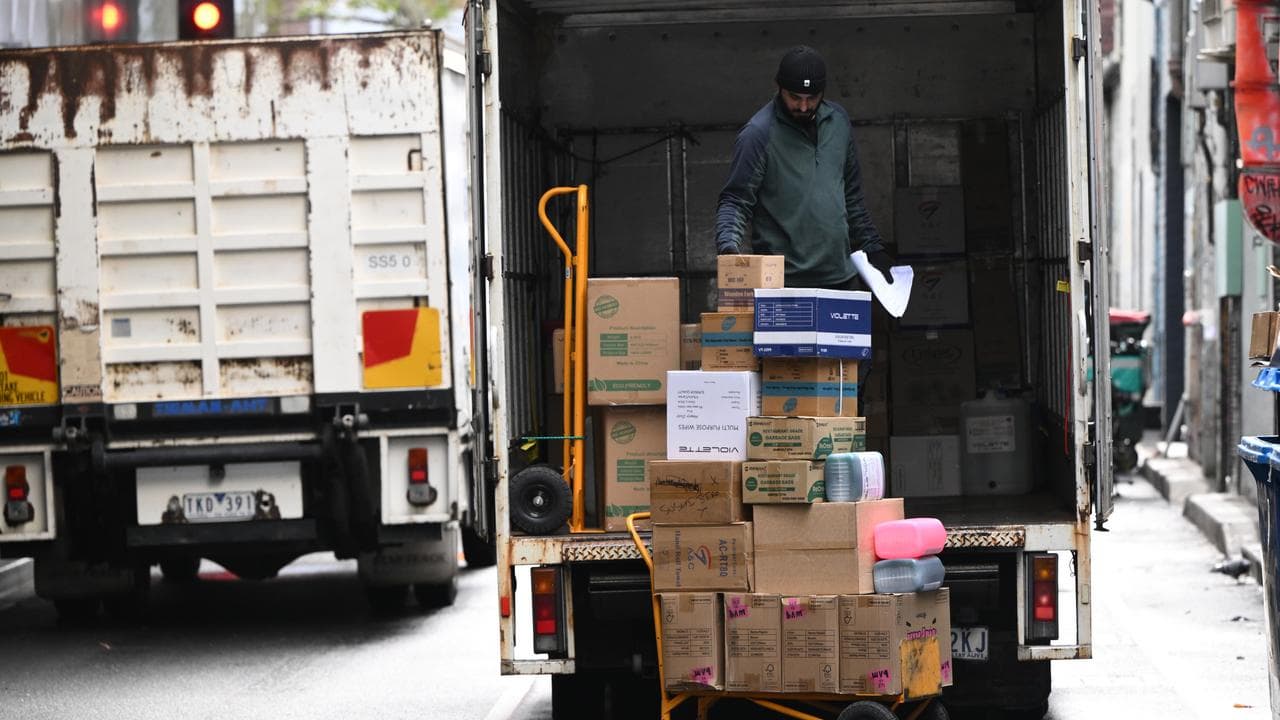 A delivery worker moves boxes in central Melbourne