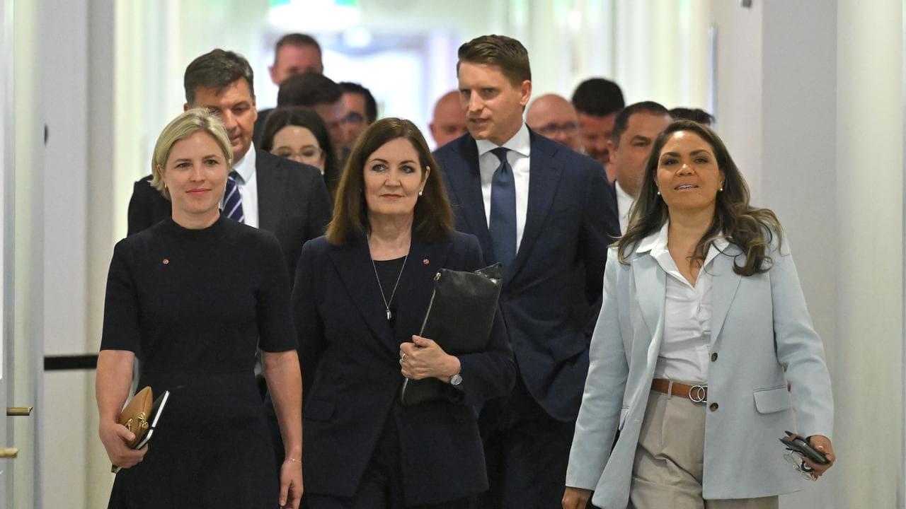 Liberal MPs and senators leave a party room meeting in Canberra