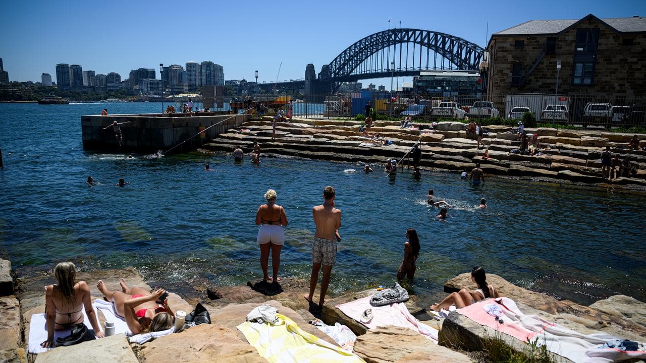 People are seen swimming and sitting in the sun at Marrinawi Cove