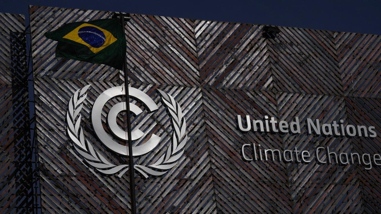 A Brazil flag flies outside the venue for the COP30