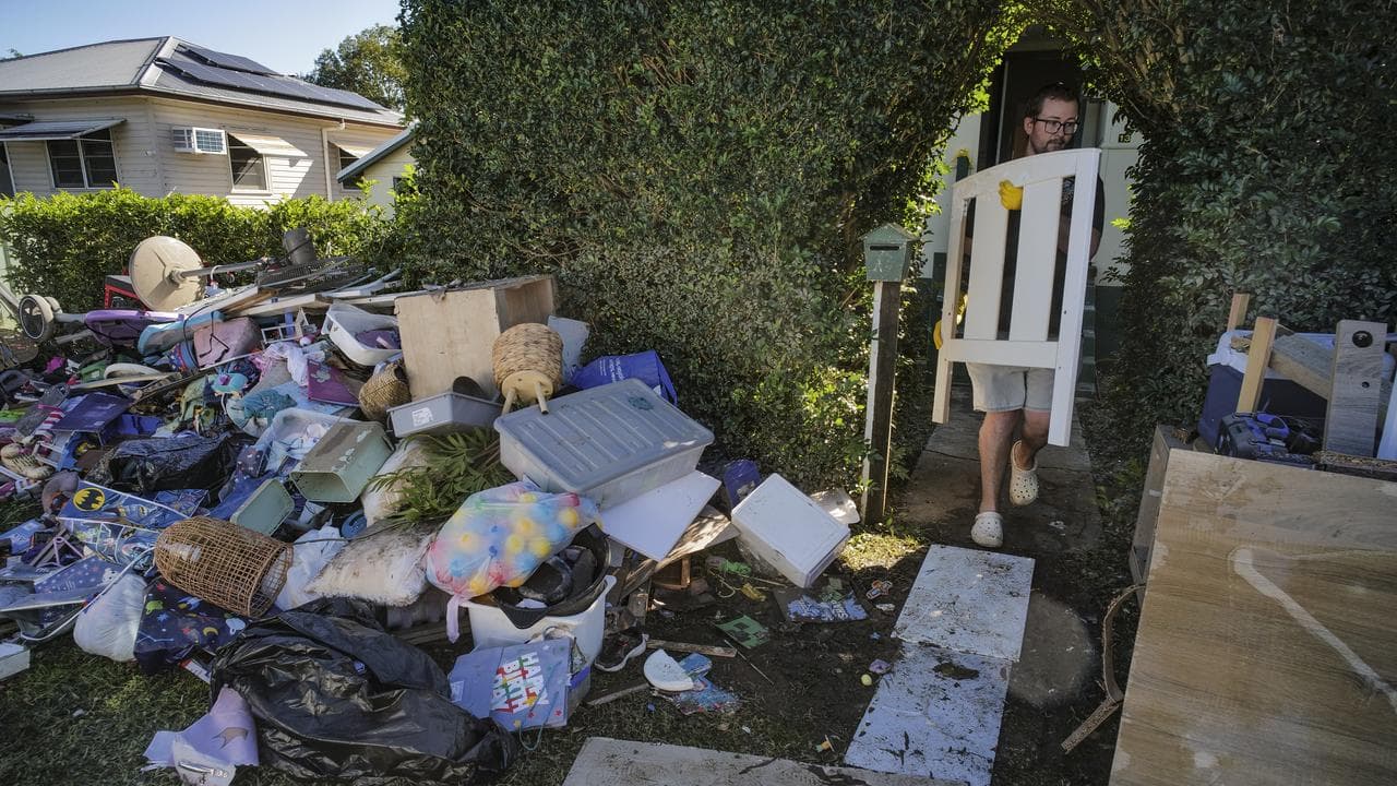 A man cleans up after flooding
