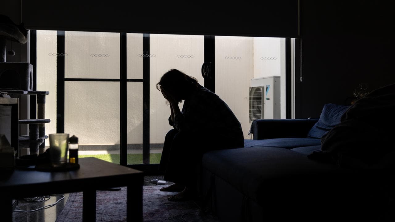 A woman with her hands over her face