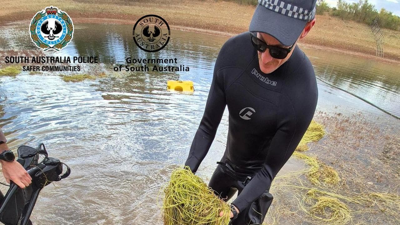 Police searching a dam
