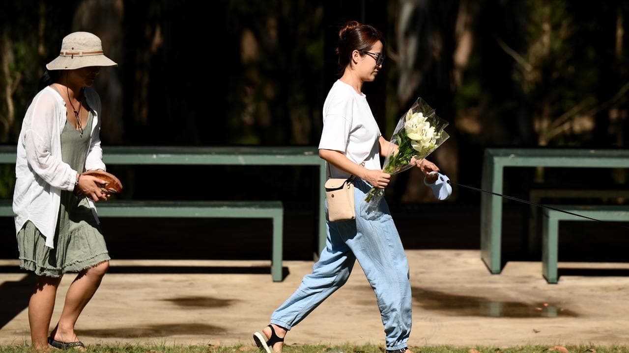 People place flowers at the scene where a teen was fatally stabbed