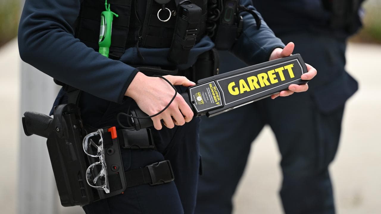 A Victoria Police officer using a metal detector (file image)
