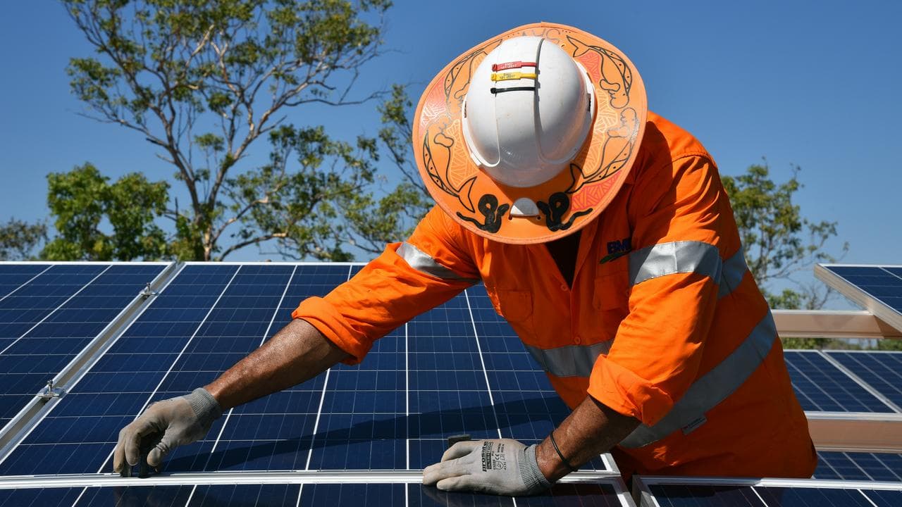 Northern Territory workers install solar panels in Daly River