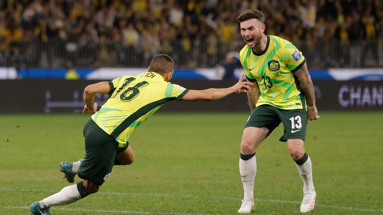 Aziz Behich celebrates a goal as Aiden O’Neill looks on