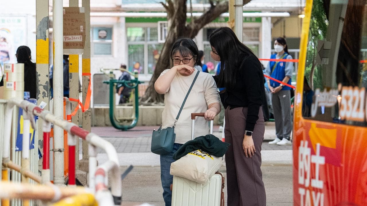 Residents return to their homes to get belongings at Wang Fuk Court