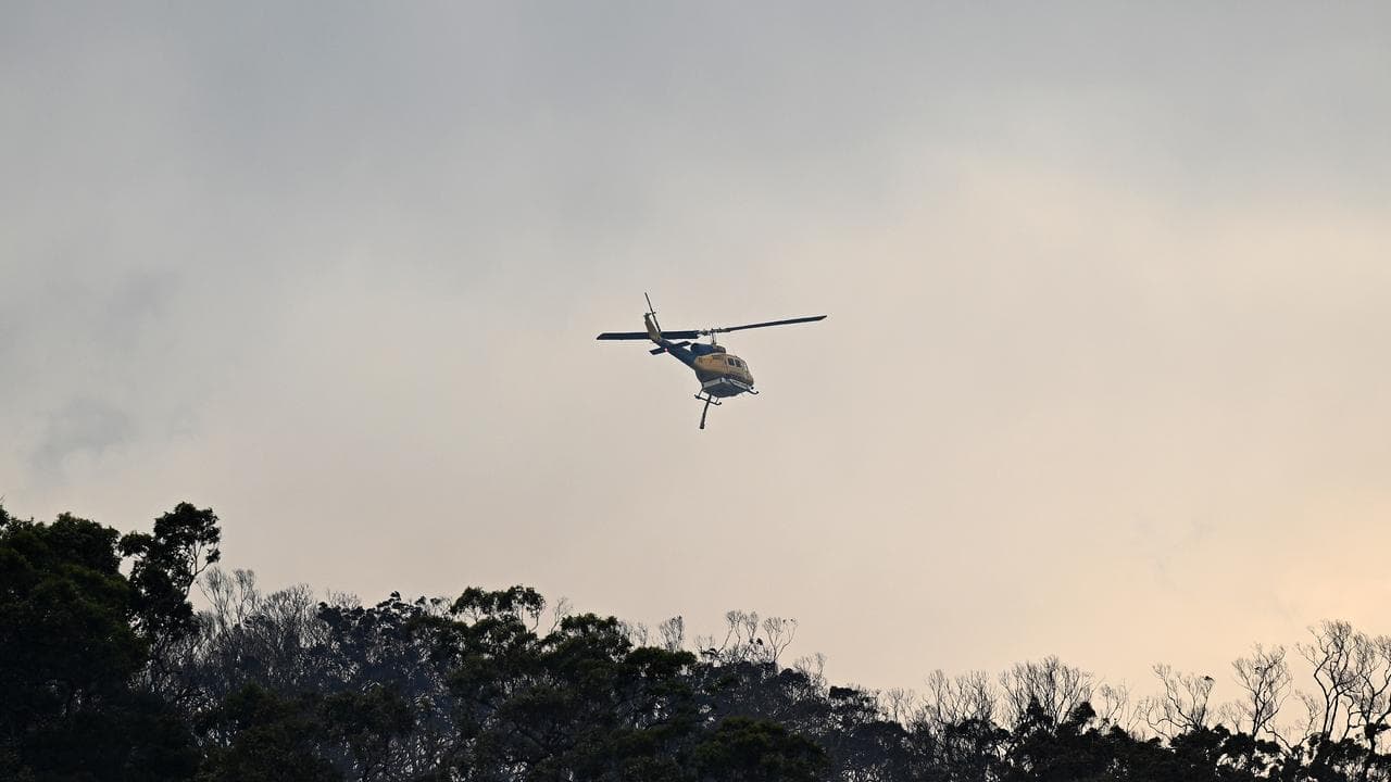 A bushfire destroys homes along Glenrock Parade in Koolewong