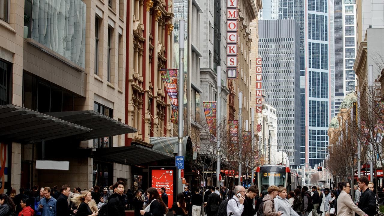 People move through George Street in the CBD of Sydney