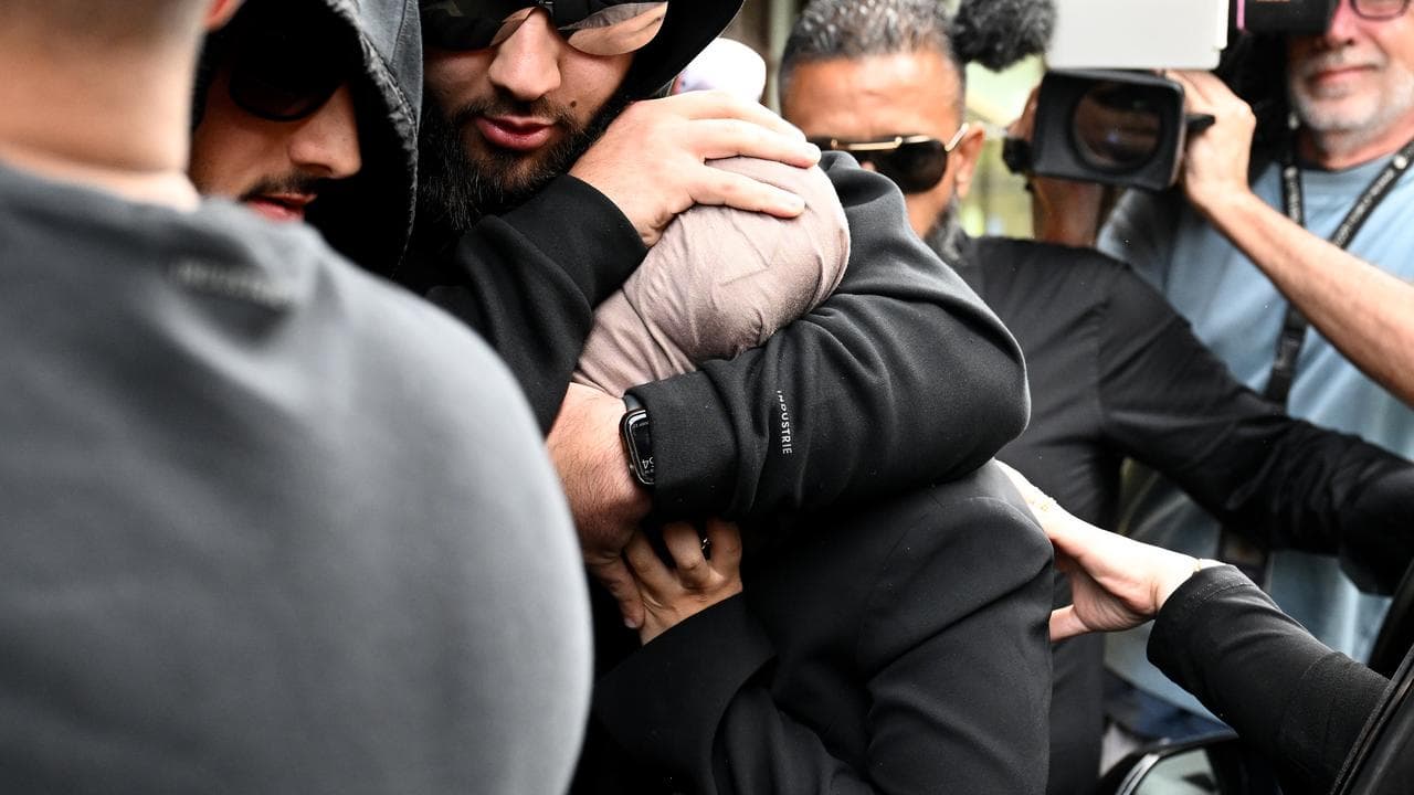 Sarah Abu Lebdeh (centre) is protected by supporters (file)