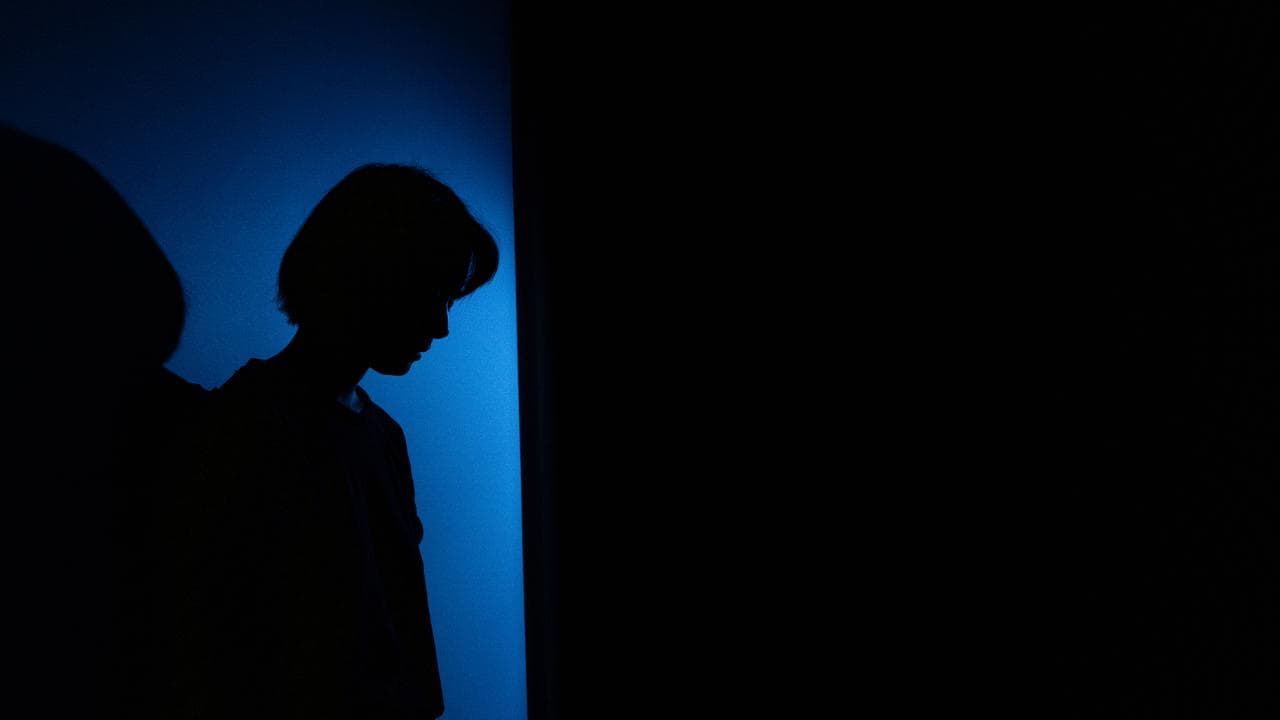A person stands beside a wall (file image)