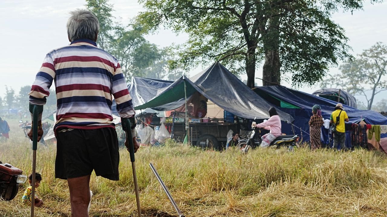 An evacuee looks towards his relatives' shelters in Cambodia