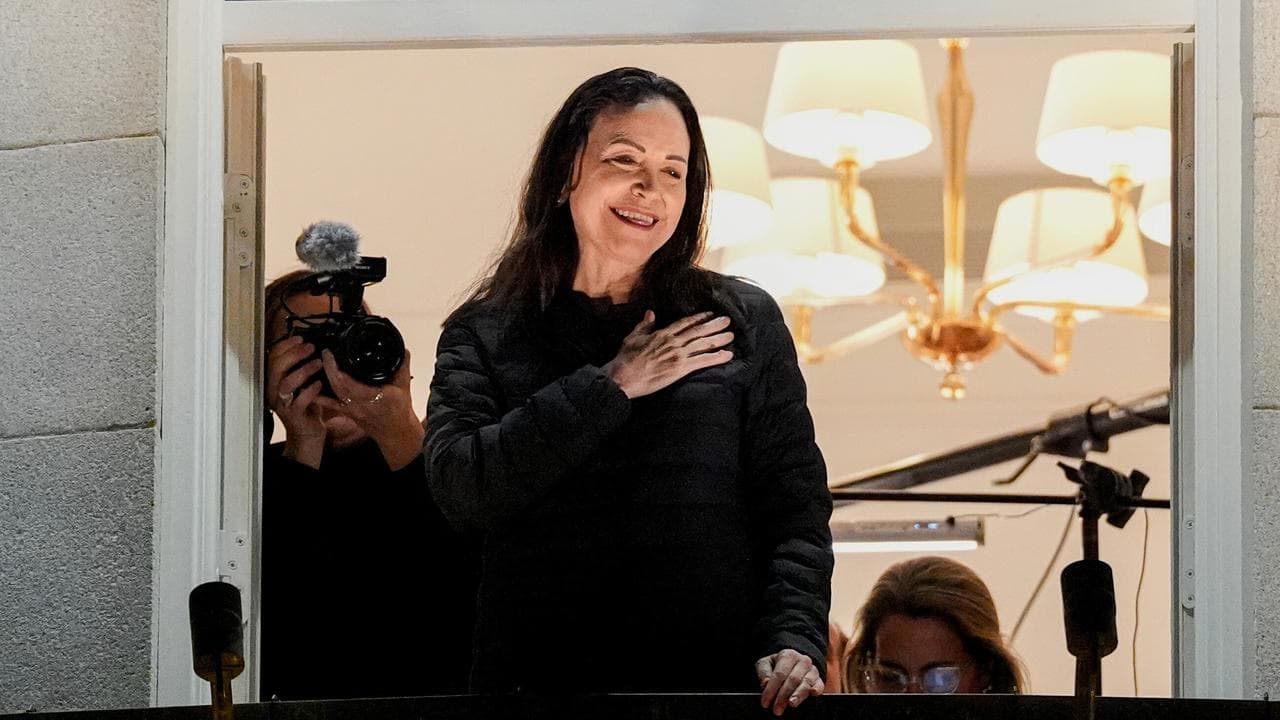 Nobel laureate Maria Corina Machado reacts to the crowd gathered below
