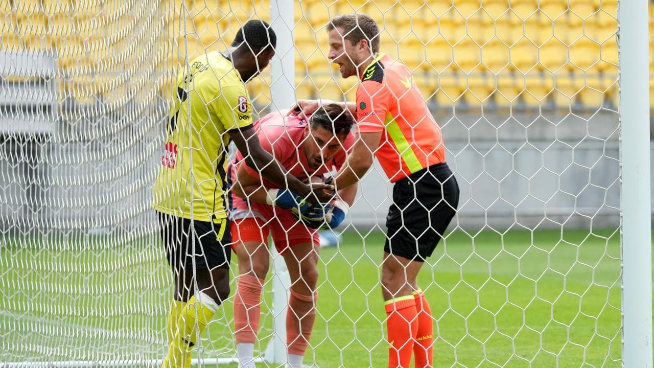 Ifeanyi Eze and Newcastle keeper James Delianov vie for the ball.
