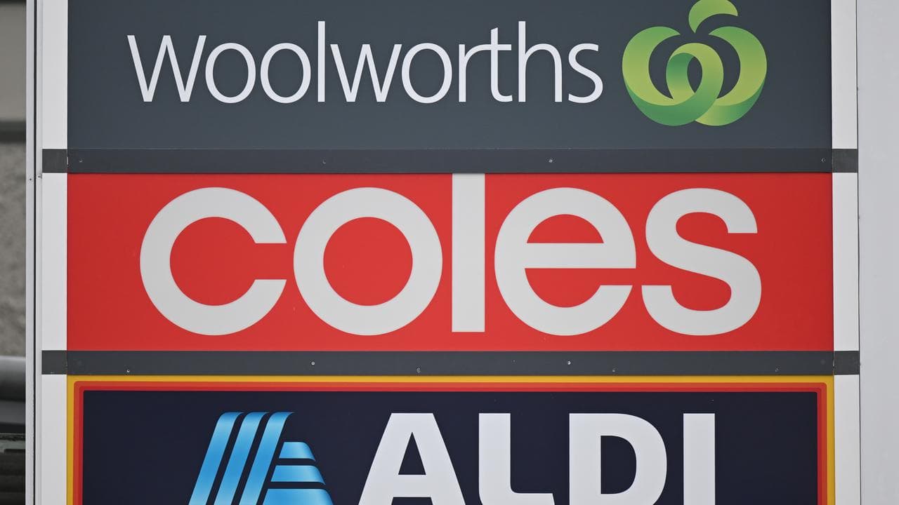 Signs and logos of Woolworths, Coles and Aldi
