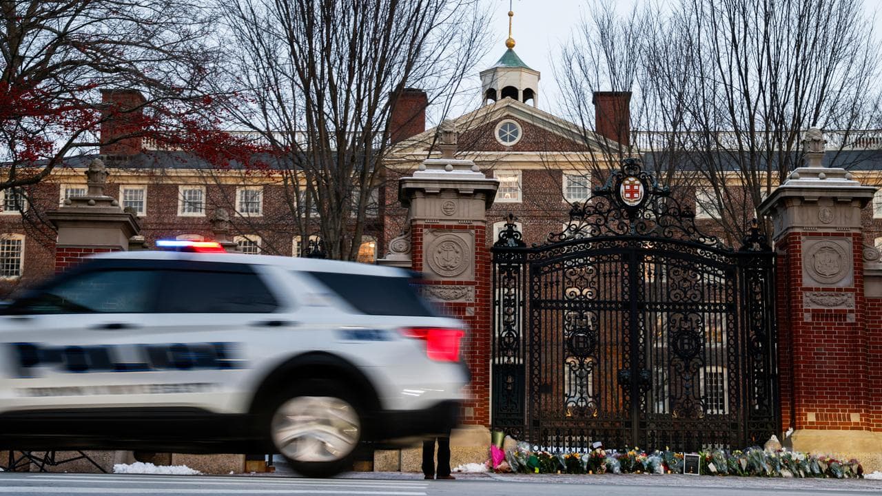 A Providence police car passes by Brown University's Van Wickle gates