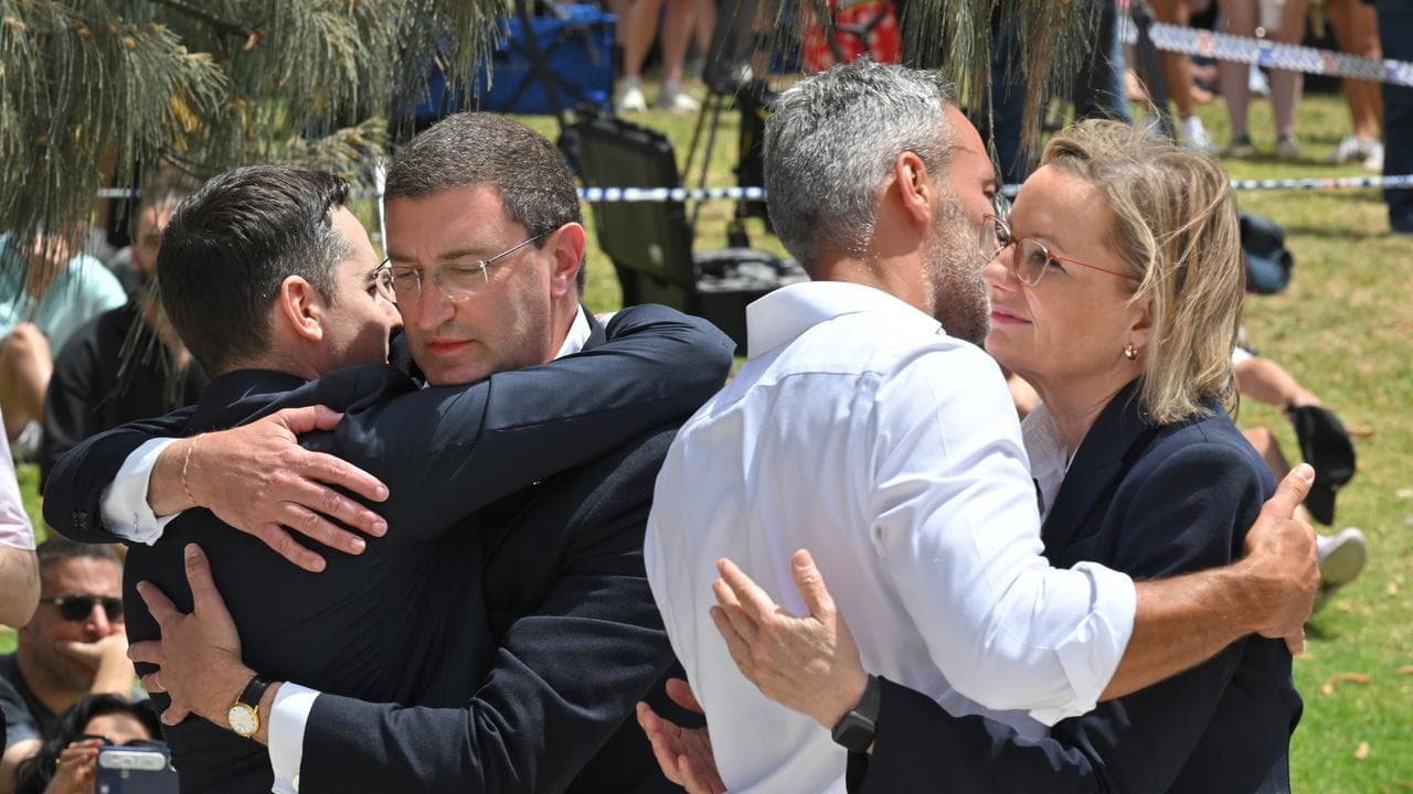 Sussan Ley hugs Alex Ryvchin  at a makeshift memorial at Bondi Beach