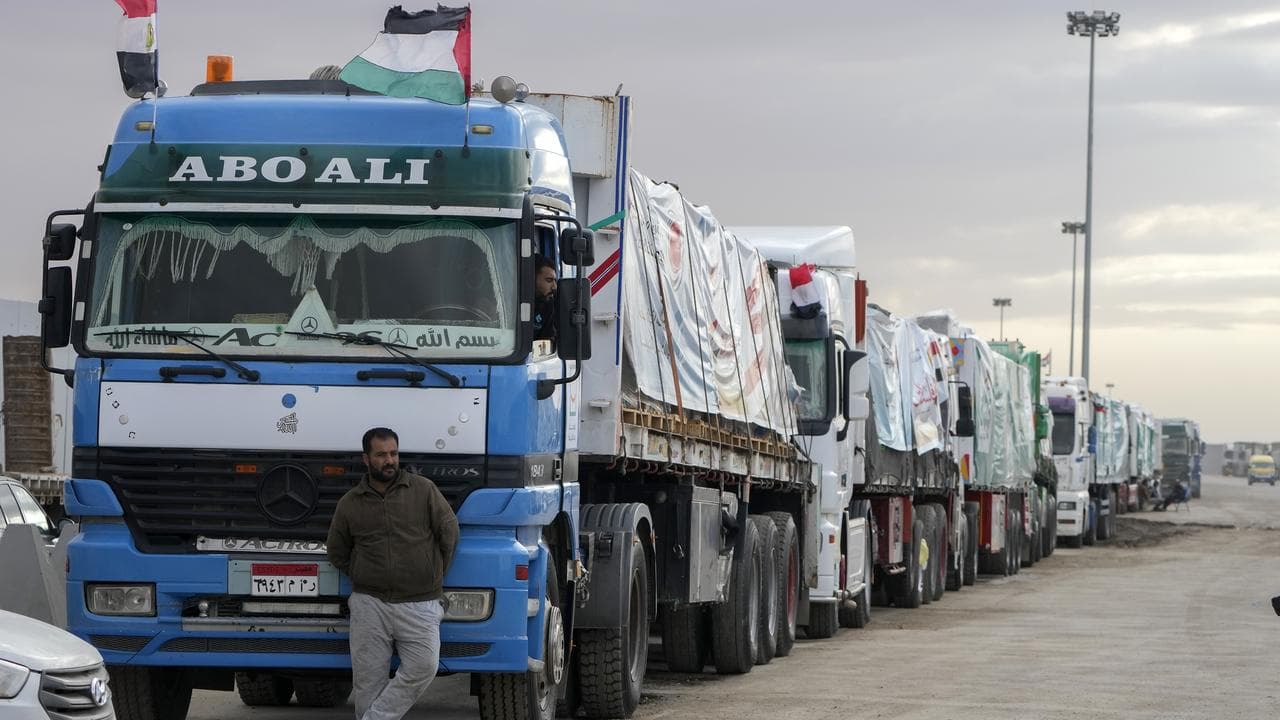 Trucks carrying aid line up at the Rafah Border Crossing