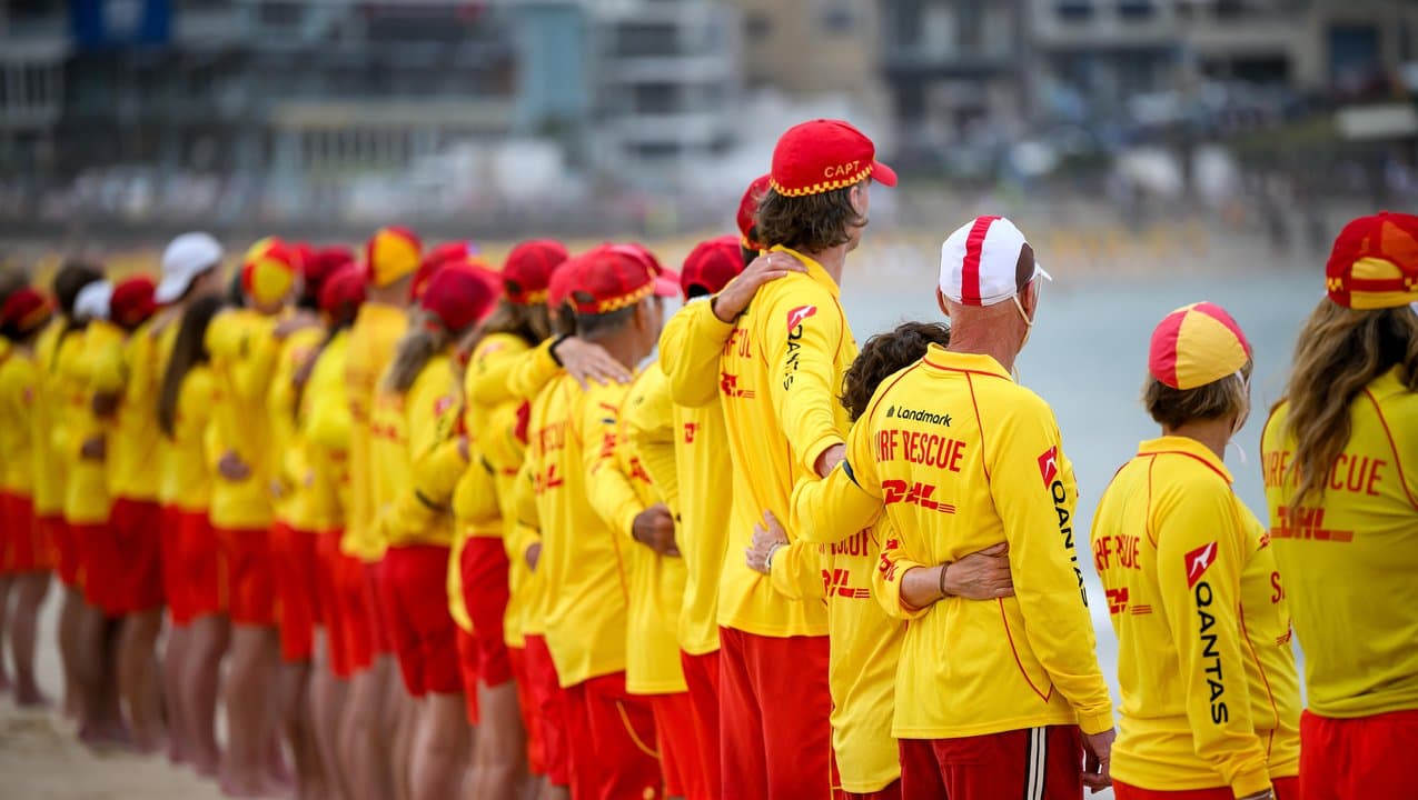 Bondi lifesavers line the shoreline