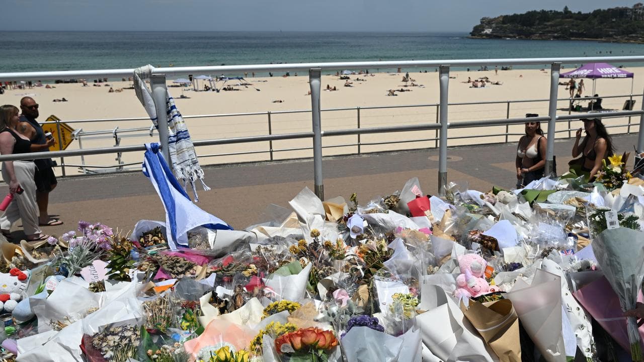 People continue to bring flowers to the Bondi Beach