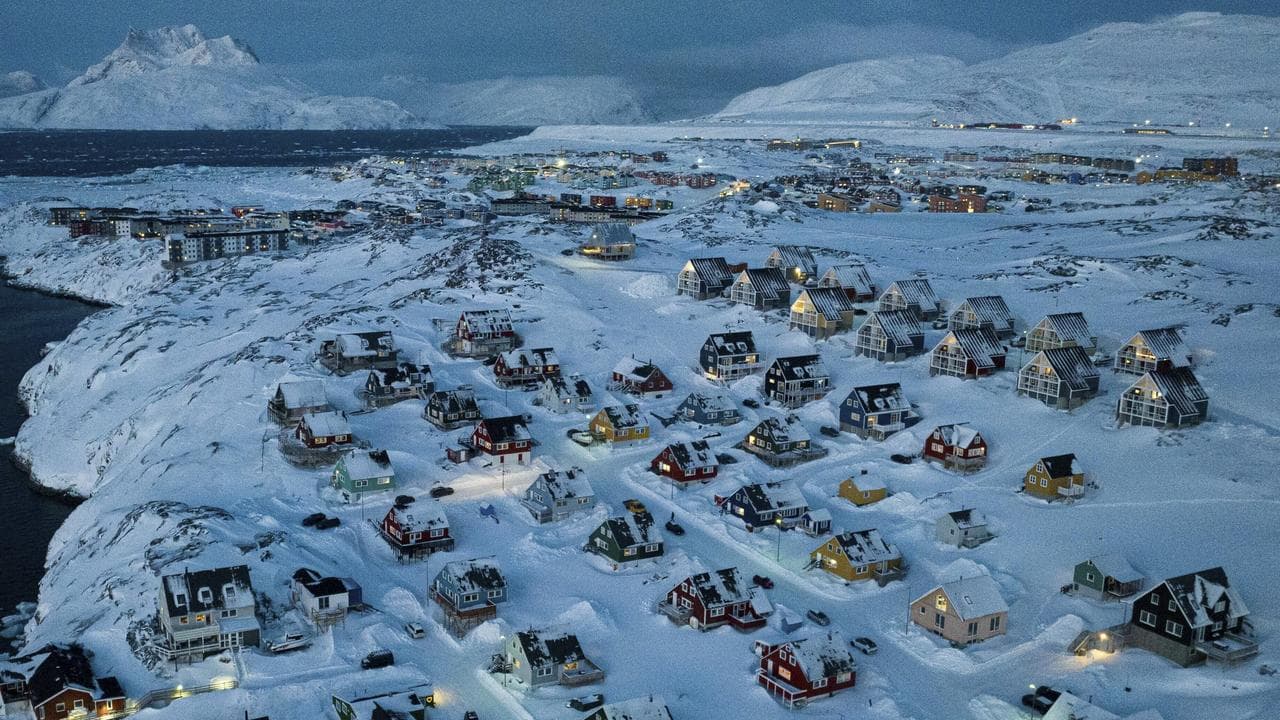 Houses covered by snow on the coast of a sea inlet at Nuuk, Greenland