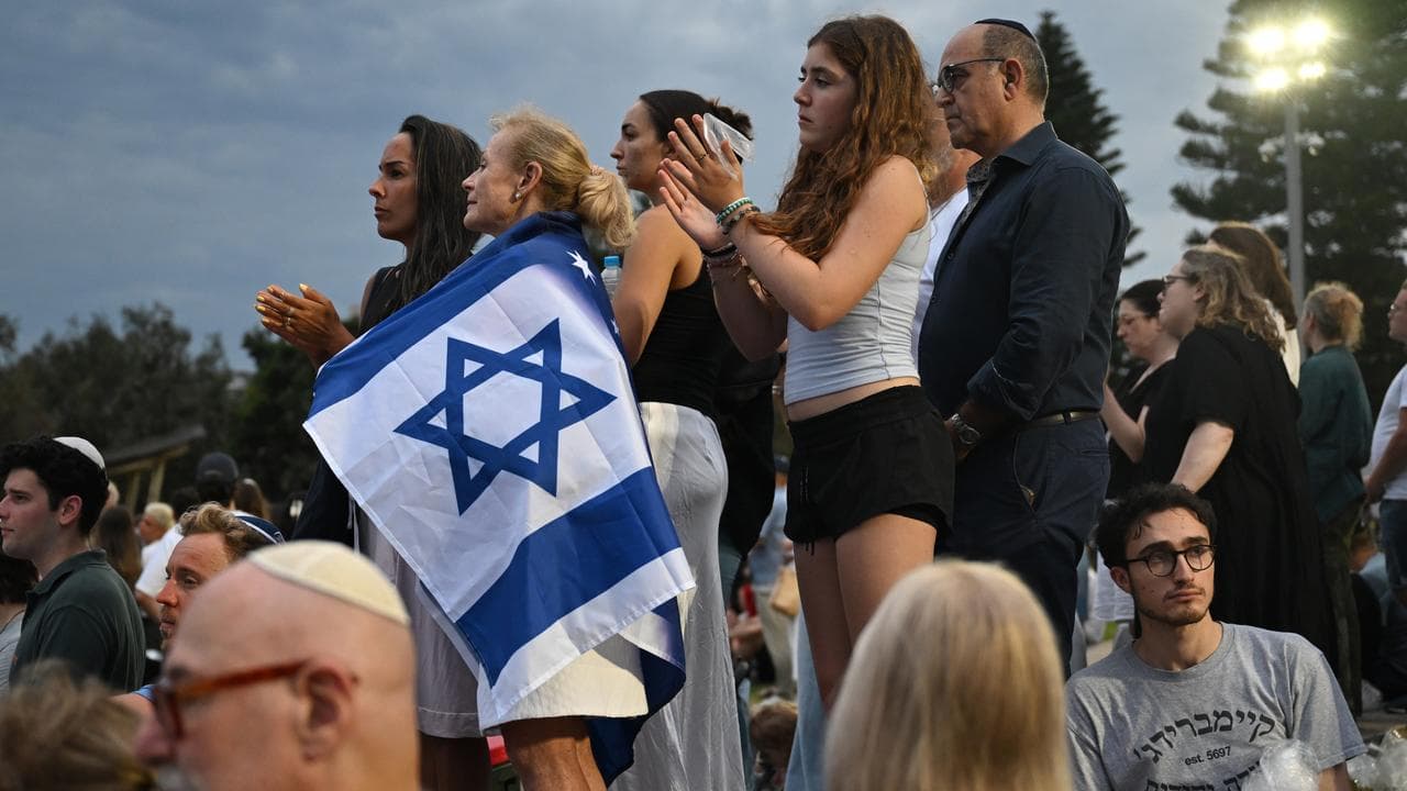 People attend a vigil after the Bondi Massacre