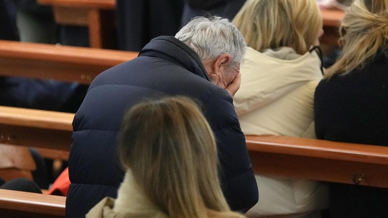 A man mourns the loss off live at the mass in Switzerland.