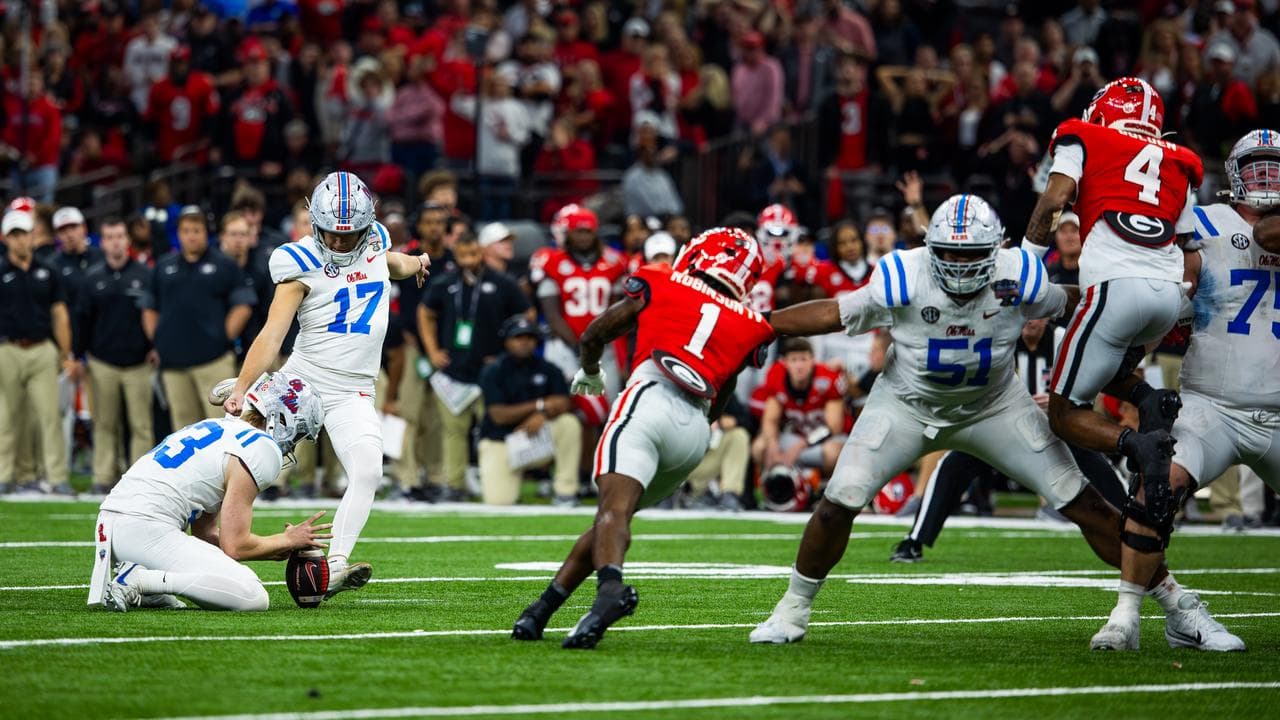 Oscar Bird holds the ball for Lucas Carneiro