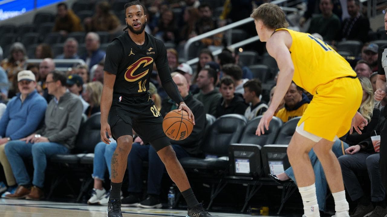 Darius Garland, left, dribbles in front of Pacers guard Johnny Furphy