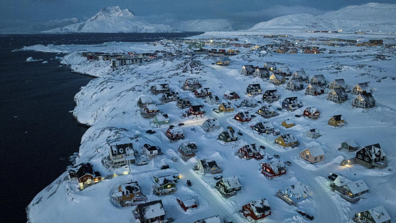 Houses covered by snow on the coast of a sea inlet at Nuuk, Greenland