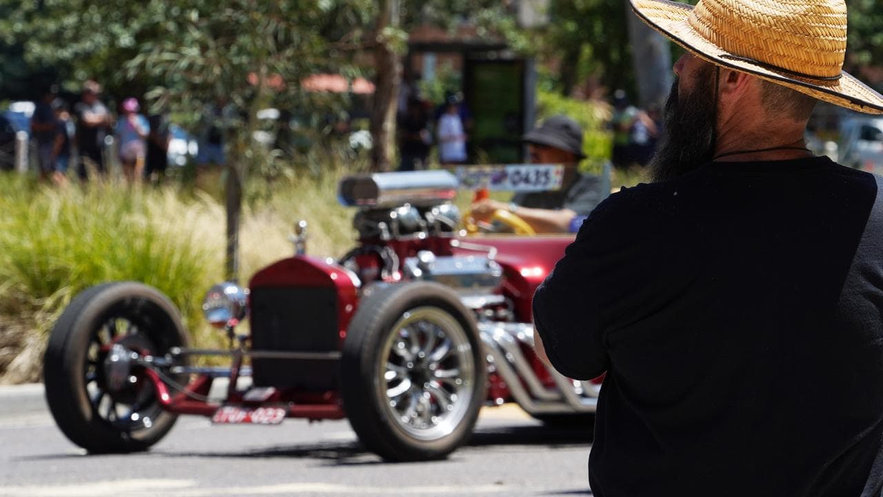 A man watches a convoy of vehicles