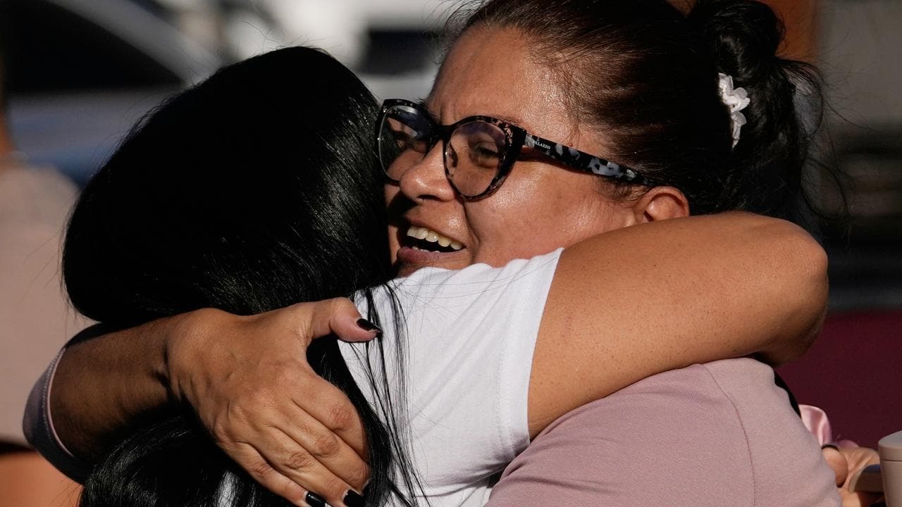 Relatives of Yosnars Baduel embrace outside prison in Venezuela