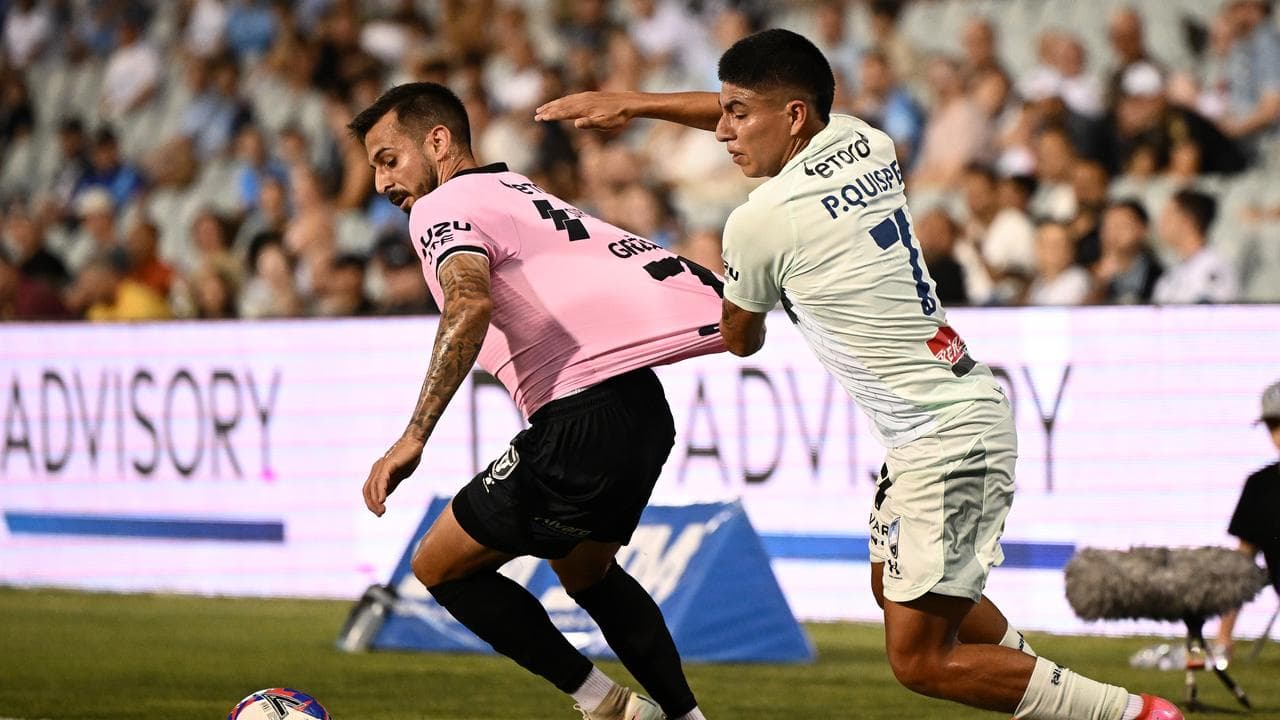 Macarthur's Sime Grzan tries to hold off Sydney's Piero Quispe.